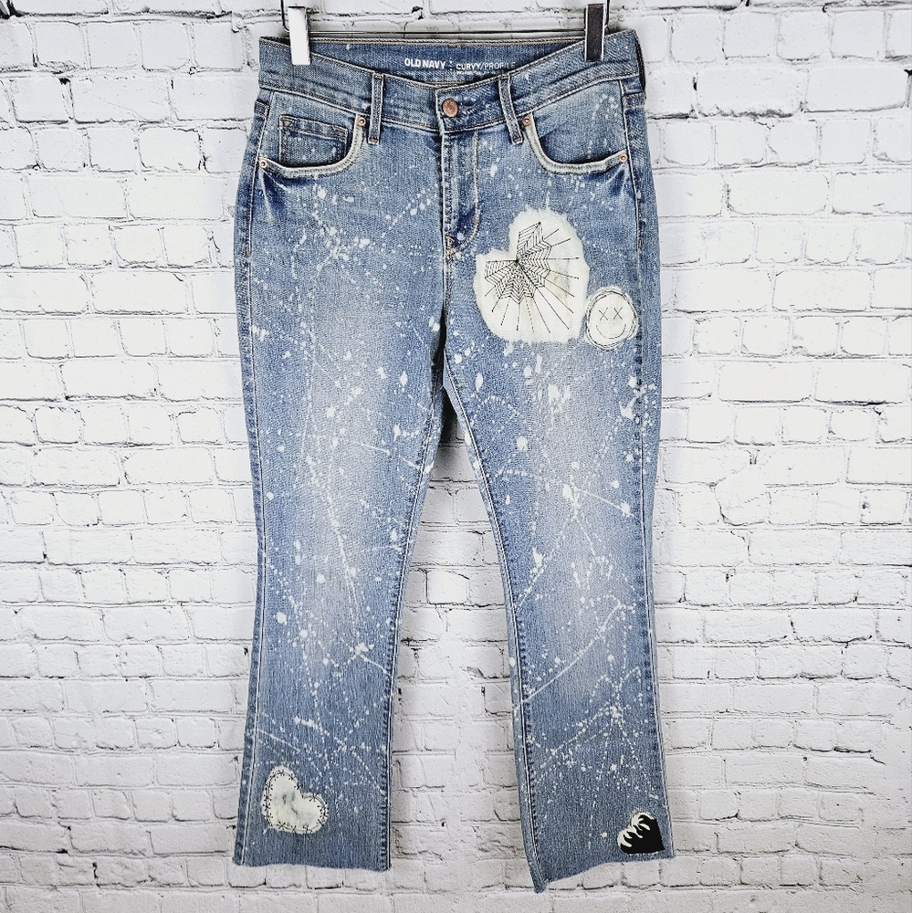 OLD NAVY | curvy mid rise bleached hearts spiderweb happy face design boot jeans